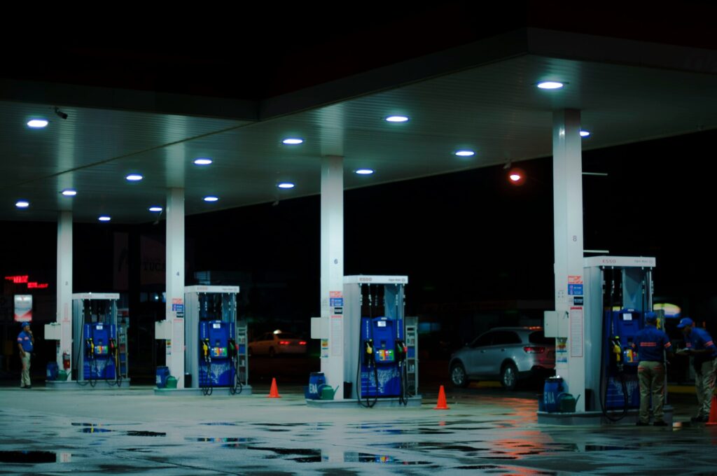 Person taking photo of blue and white gasoline station