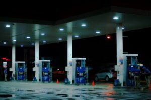 Person taking photo of blue and white gasoline station